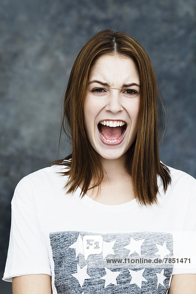 Portrait of young woman shouting