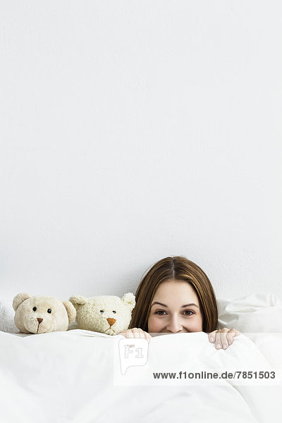 Young woman playing with teddy bear