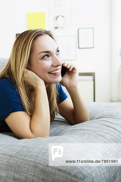 Young woman talking on mobile phone  smiling