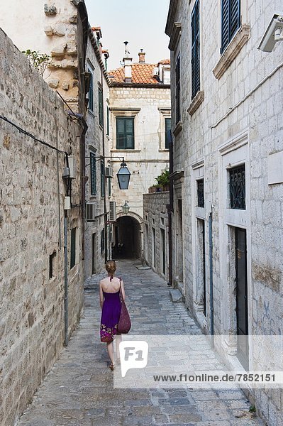 Dubrovnik Old Town  a tourist walking along a narrow side street  Dubrovnik  Croatia  Europe