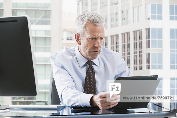 Caucasian businessman using tablet computer