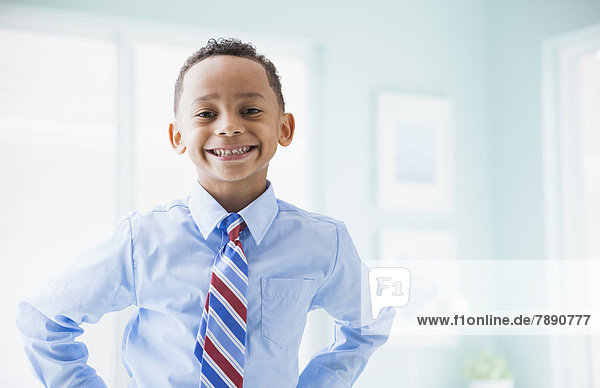 Mixed race boy wearing shirt and tie