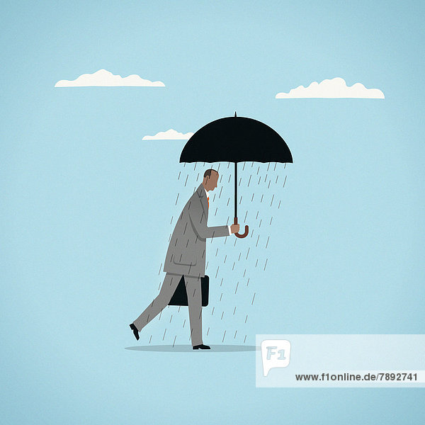 Regen fällt aus einem Regenschirm auf einen Geschäftsmann