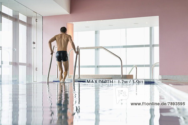 Man coming out from a swimming pool