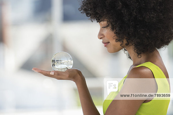 Close-up of a woman holding a crystal ball