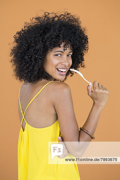 Portrait of a woman holding a fork and smiling