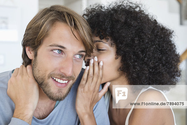 Woman whispering to a man