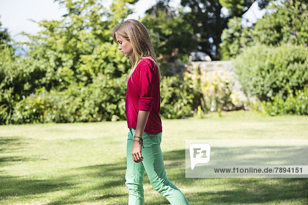 Girl walking on the grass in a lawn