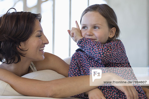 Woman smiling with her daughter at home