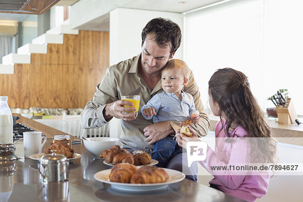 Family having breakfast at a kitchen counter