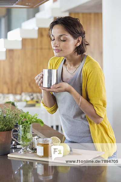 Woman smelling herbal tea