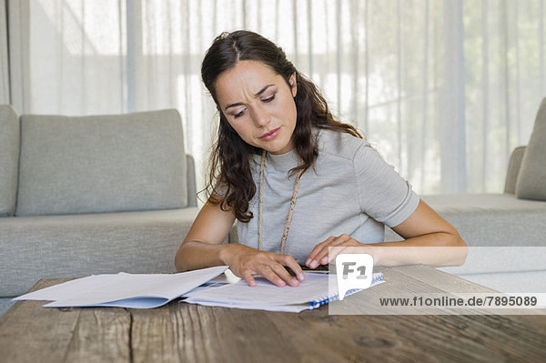 Woman doing paperwork at home