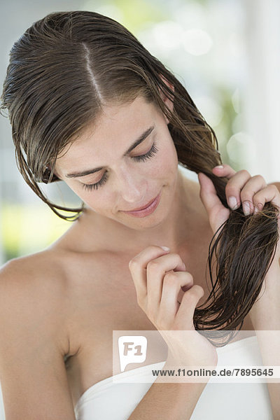 Woman applying conditioner in her hair