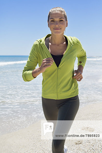 Portrait of a woman running on the beach