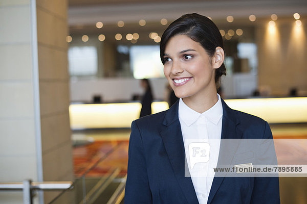 Receptionist smiling in a hotel lobby