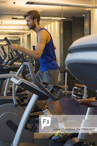 Man exercising on a machine in a gym