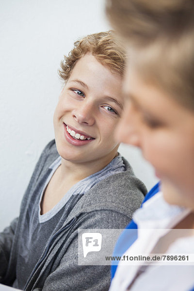 Close-up of two teenage boys smiling