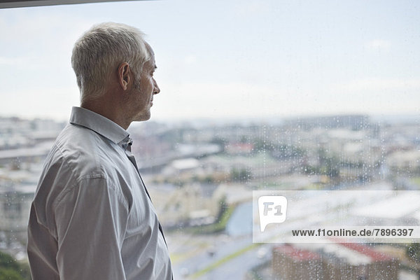 Man looking through a window