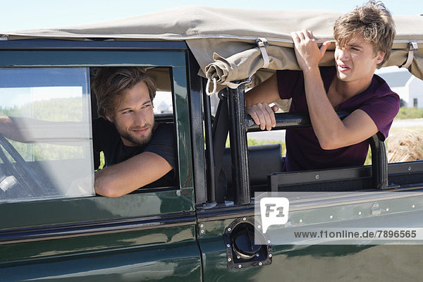 Zwei männliche Freunde in einem SUV