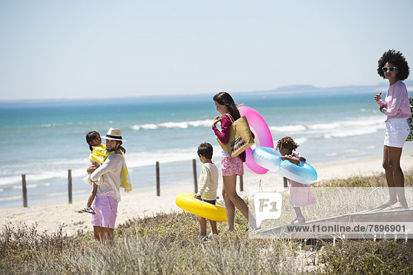 Family walking on a boardwalk on the beach