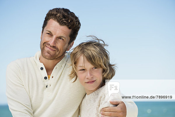 Man with his son on the beach