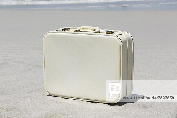 Close-up of a suitcase on the beach