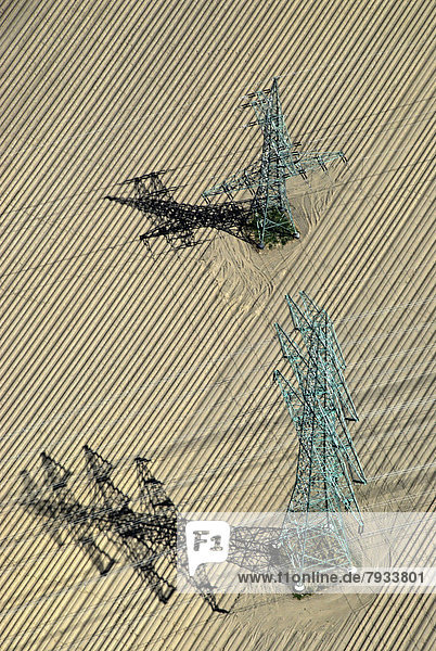 Aerial view  high-voltage transmission masts in a field