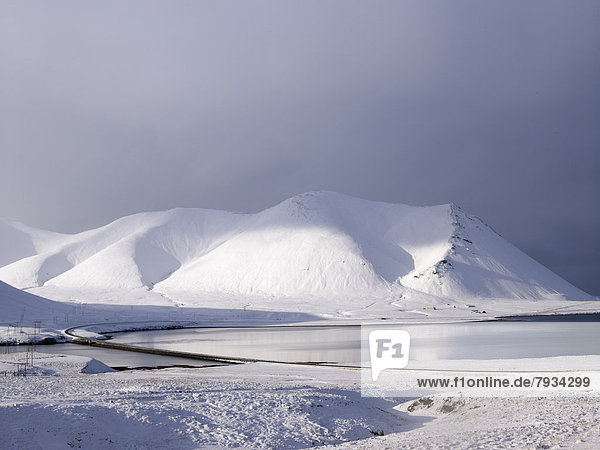 Volcanic lake with snow capped mountains on Ring Road No 1