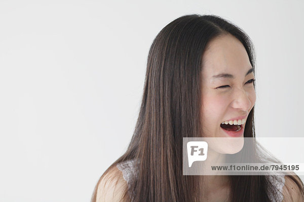 Young woman with long hair laughing