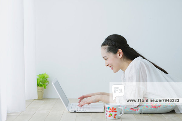 Young woman with laptop in the living room