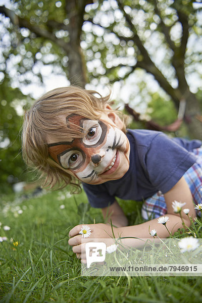 Junge  4 Jahre  im Garten mit als Hase geschminktem Gesicht