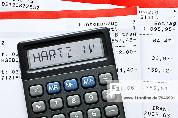 'Calculator with the term ''Hartz IV'' in the display and bank statements'