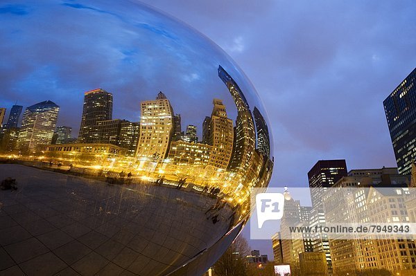 The Chicago skyline is reflected at dusk in the Cloud Gate sculpture informally known as The Bean in Millennium Park in Chicago  IL.