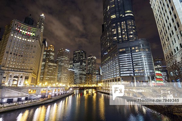 Looking down the Chicago River at the Chicago skyline and Trump Tower at night in Chicago  IL.