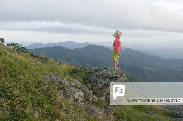 A young girl standing on a rock on Grassy Ridge  Bakersville  North Carolina.