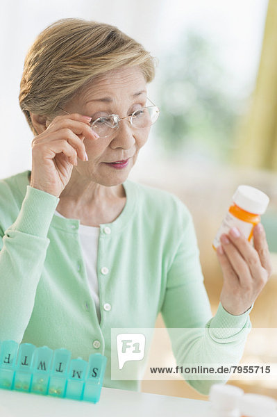 Senior woman reading medicine label