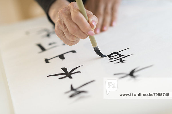 Female hand and japanese calligraphy