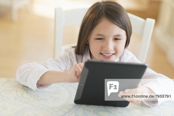 Girl (8-9) using digital tablet