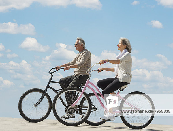 Senior couple riding bicycle