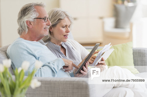 Senior couple paying bills via internet