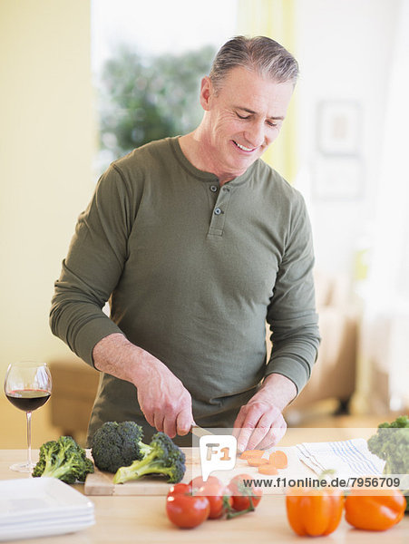 Portrait of man cutting vegetables