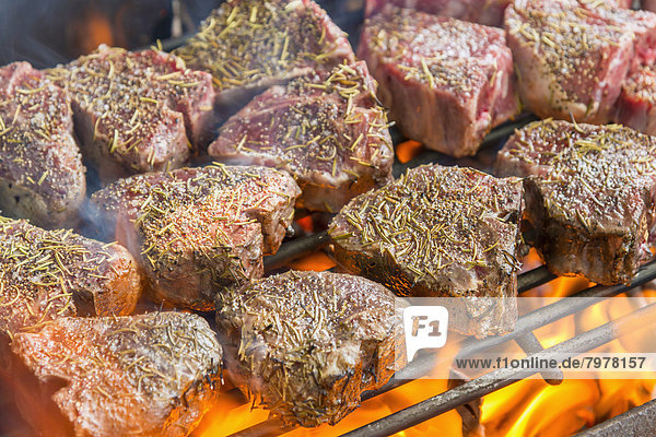 Grilling T bone steaks on barbecue,  close up