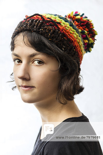 Portrait of teenage girl against white background  close up