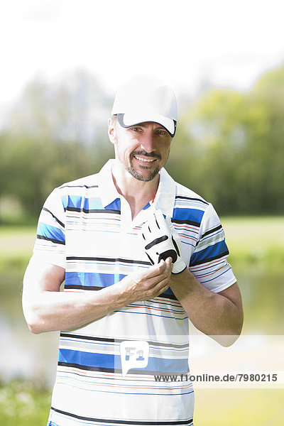 Portrait of man on golf course  smiling