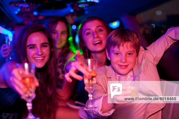Young women and boy in limousine
