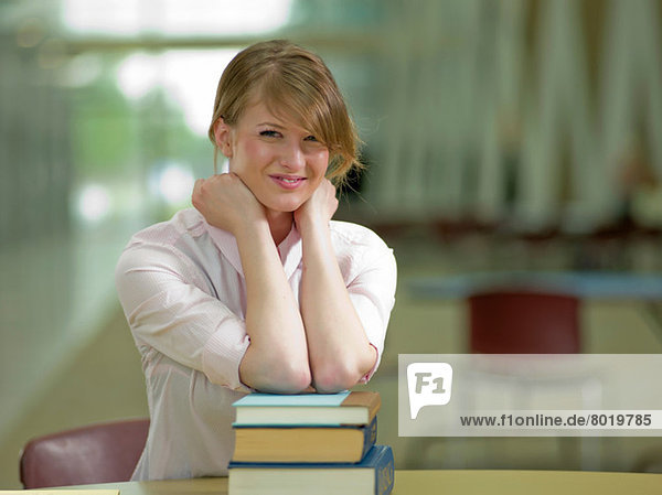 Young student leaning on school books  portrait