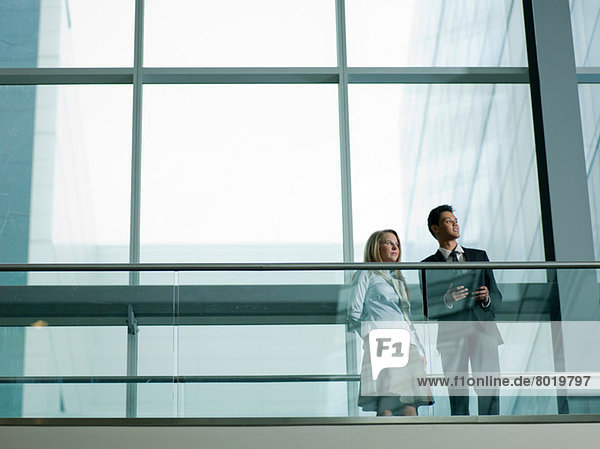 Young business colleagues standing in modern building