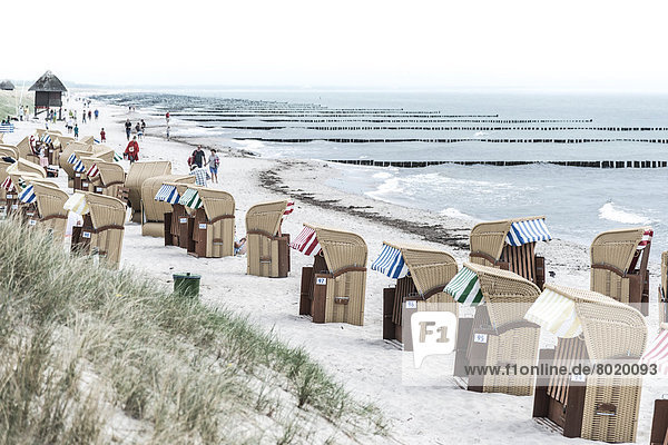 Roofed wicker beach chairs on a beach on the Baltic Sea coast