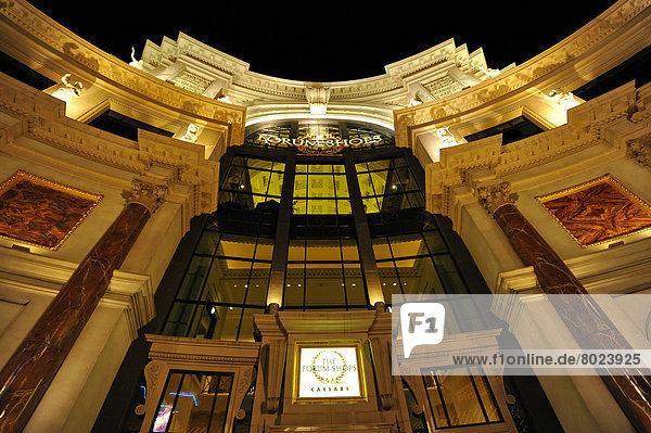 Night scene  entrance to The Forum Shops  luxury hotel and casino  Caesar's Palace