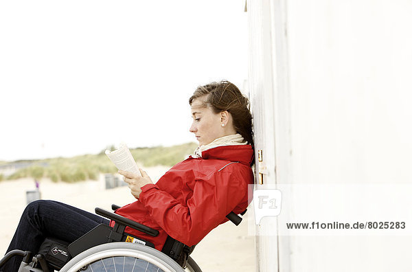 Female wheelchair user on the beach.